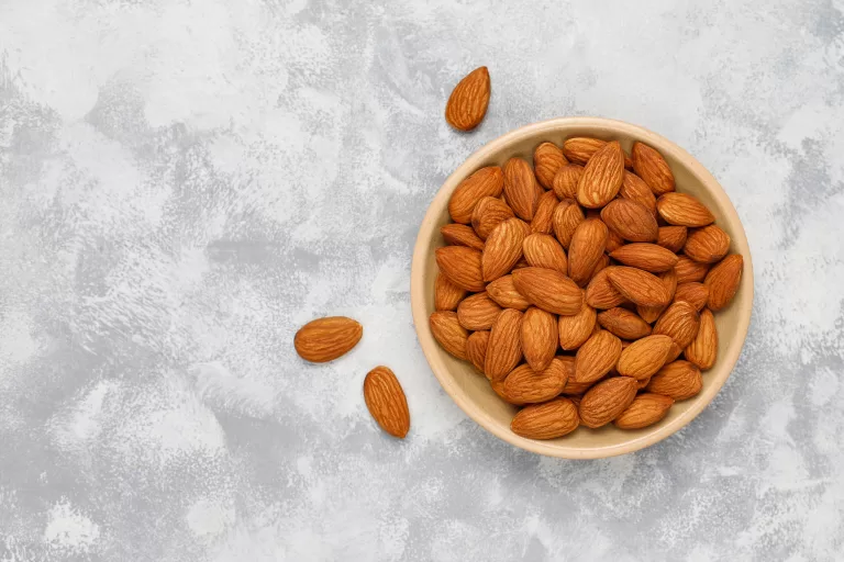 fresh almonds ceramic plates top view